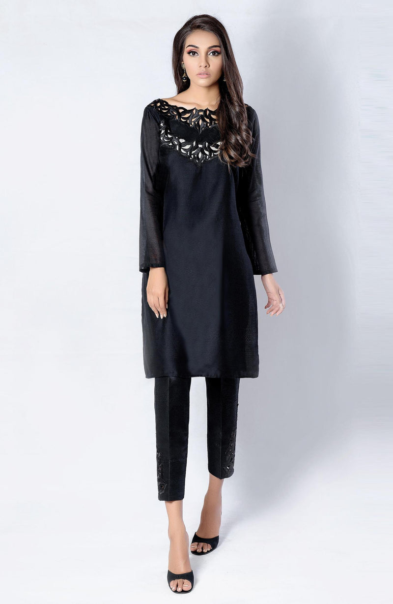 Black tunic with cutwork neckline.